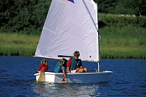 Young family sailing a Vanguard Pram on Cape Cod, USA