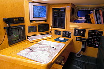 Navigation station of a 70ft yacht showing electronic navigation equipment.