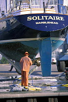 Pressure washing the slimy bottom of cruising yacht, "Solitaire".