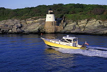 Little Harbor Whisperjet powerboat cruising off Castle Hill Lighthouse, Rhode Island, USA.