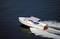 Huckins powerboat in a glassy calm sea off Newport, Rhode Island, USA.