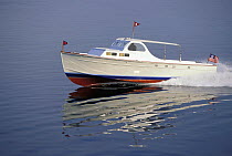 Huckins powerboat in a glassy calm sea off Newport, Rhode Island, USA. Property Released.