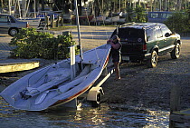 Viper dinghy hauled out a on trailer behind SUV.