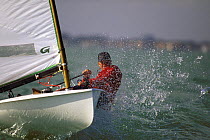 Europe dinghy launches off wave with spray during Canadian Olympic trials in Miami, Florida, USA