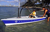 Father and son rigging a sailboat in Miami, Florida, USA