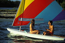 Young couple sailing a Sunfish dinghy off Cape Cod, USA