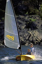 Mother and child sailing a plastic roto moulded Escape dinghy. ^^^ These boats are aimed at beginners and provide an inexpensive solution to getting children out on the water.