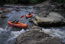 Kayakers on river rapids, Honduras.