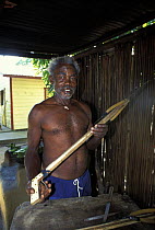 Local man proudly displaying homemade harpoon, Roatan, Honduras.
