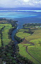 Aerial view of Mauritius with a boat travelling up river.