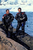 Two divers Matteo Diana (left) and  Roberto Rinaldi (right) ready for a dive in the water of Largo Argentino in front of Perito Moreno glacier, Los Glaciares National Park, Patagonia, Argentina