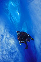 A diver in a crevasse inside the Perito Moreno glacier, Los Glaciares National Park, Patagonia, Argentina