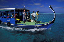 Divers on board a dhoni, a typical Maldivian style diveboat, Maldives.