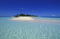 Island with white sand and palm trees, surrounded by clear waters, Maldives.