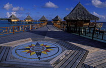 Traditional Tahitian styled bungalows on stilts. Kia Ora resort, Rangiroa, Polynesia.