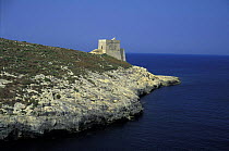 A fortification on the water's edge along the cliff lined coast at Dwejra, Gozo, Malta