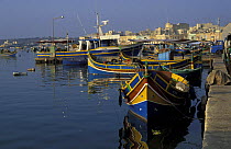 Kajjieks, the traditional colourful eyed Maltese fishing boats. The painted eyes are supposed to keep evil away, Marsaxlokk harbour, Malta