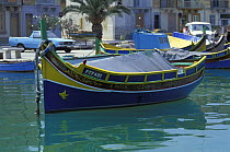 A traditional luzzu fishing boat moored in Marasaxlokk Harbour, Malta