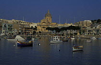 Fishing boats in the harbour that separates Cospicua from Vittoriosa in Malta.