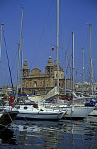 Yachts in the harbour of Msida with St Joseph church in the background, Malta