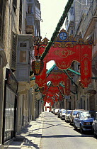 Street decorated for feast celebrating a Saint, Malta. ^^^In summer time these kind of festivals are very common with processions marching through decorated streets.