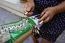 Woman weaving traditional hand-made lace, Gozo, Malta.