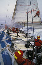 Safety rope held by crew in the cockpit whilst crewman climbs the mainsail aboard Drum during the Whitbread Round the World Race, 1985. Drum was owned and crewed by Simon le Bon, lead singer of the po...