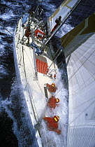 Four crew prepare for a sail change on "Drum" during the Whitbread Round the World Race, 1985-6.