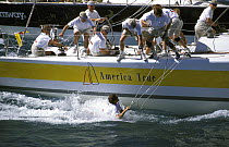 Crewman has fallen overboard on "America True" but managed to keep hold of a line at SORC, 1998.