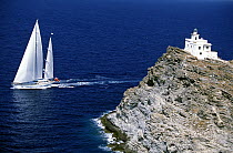The 147 foot, Dubois superyacht 'Timoneer' sails in the blue waters off a lighthouse in Greece.