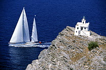 147ft Dubois superyacht ^Timoneer^ sailing in the blue waters off a lighthouse in Greece.