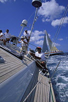 Winchman aboard Farr 72 "Starr Trail" during racing at Grenada Sailing Festival, Caribbean, January 1998.