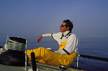 Tim Laughridge relaxing on Farr 60 "Rima" while on watch during the Newport Bermuda race, 1998.