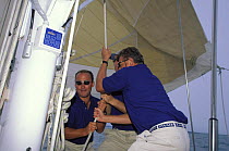 Crew bouncing the halyard to hoist the Spinnaker on Swan 77 "Pamina"