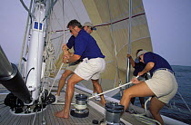 Crew hoisting spinnaker aboard Swan 77 "Pamina"