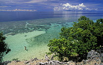 Woman entering clear waters on southern tip of Walea Island, Togian Islands, Sulawesi.