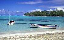 Two open boats moored close to the beach, Mauritius.