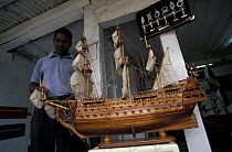 Man with model multi-rigged tall ship, Mauritius.  Warship "Soleil Royal".