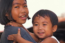 Girl taking care of her little brother, Puerto Princessa, Philippines. 2001