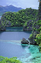Limestone cliffs clear water in lagoon, Kayangan Lake, Coron Island, Palawan, Philippines.