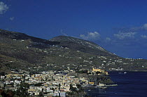 Lipari town with castle on island of the same name. Lipari is the main island of the seven Aeolian islands, Italy. In the background is Vulcano.