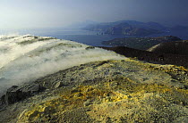 Sulphuric gases coming out of a fumerole next to the big crater (Fossa di Vulcano) on Vulcano, Aeolian Islands, Italy. In the background is Lipari Island.