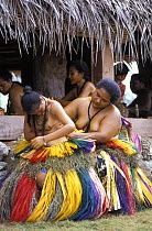 Yapeese girls dressing for the dancing at a local feast, Yap, Micronesia