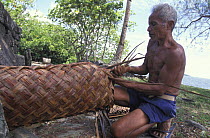 Man weaving a Yap style bag, Micronesia.