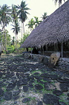 Traditional Yap style house with stone money in front, Micronesia