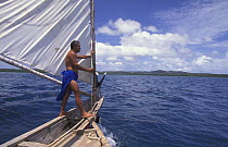 Man sailing a popow, the traditional outrigger canoe used on Yap, Micronesia. ^^^The popow is characterized by v shaped ends, used for travel and fishing. The popows are designed so that the mast can...