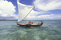 Men sailing a popow, the traditional outrigger canoe used on Yap, Micronesia. ^^^The popow is characterized by v shaped ends, used for travel and fishing. The popows are designed so that the mast can...