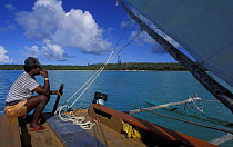 Man sailing a pirogue boat in Baie d'Upi, Ile de Pins, New Caledonia, Melanesia