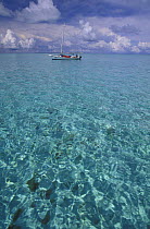 Fishing boat in the clear turquoise waters around the reef, Belize