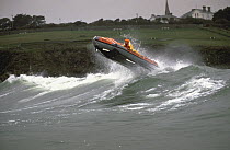 Breaking through the surf, the inshore D Class lifeboat based at Tramore on the south coast of Ireland.